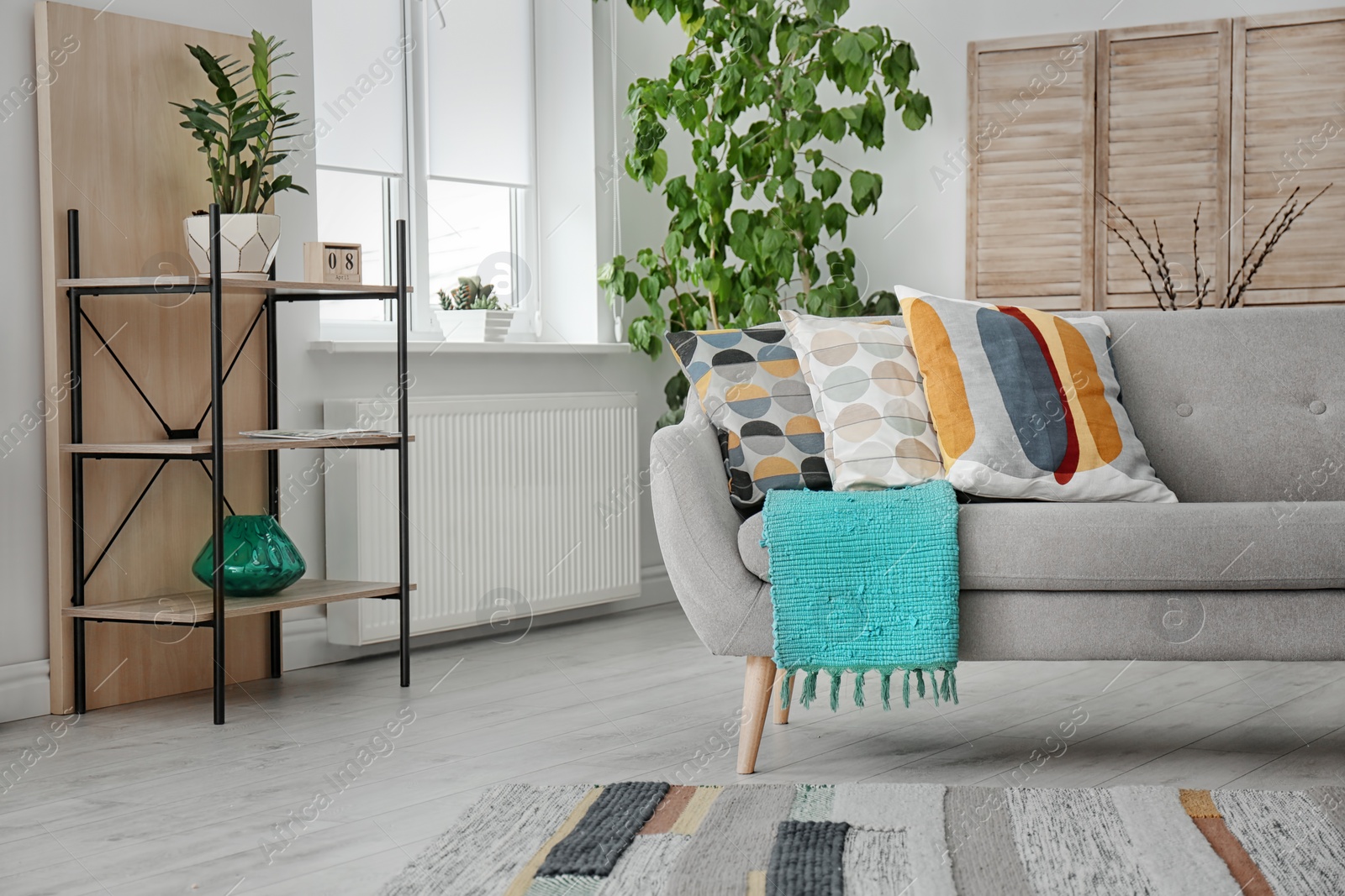 Photo of Elegant sofa with soft pillows in living room interior