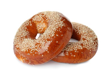 Delicious fresh bagels with sesame seeds on white background