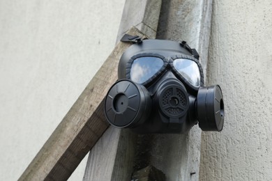 Photo of One gas mask hanging on building outdoors, low angle view