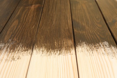 Photo of Wooden surface covered with wood stain, closeup