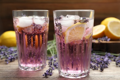 Photo of Fresh delicious lemonade with lavender on wooden table