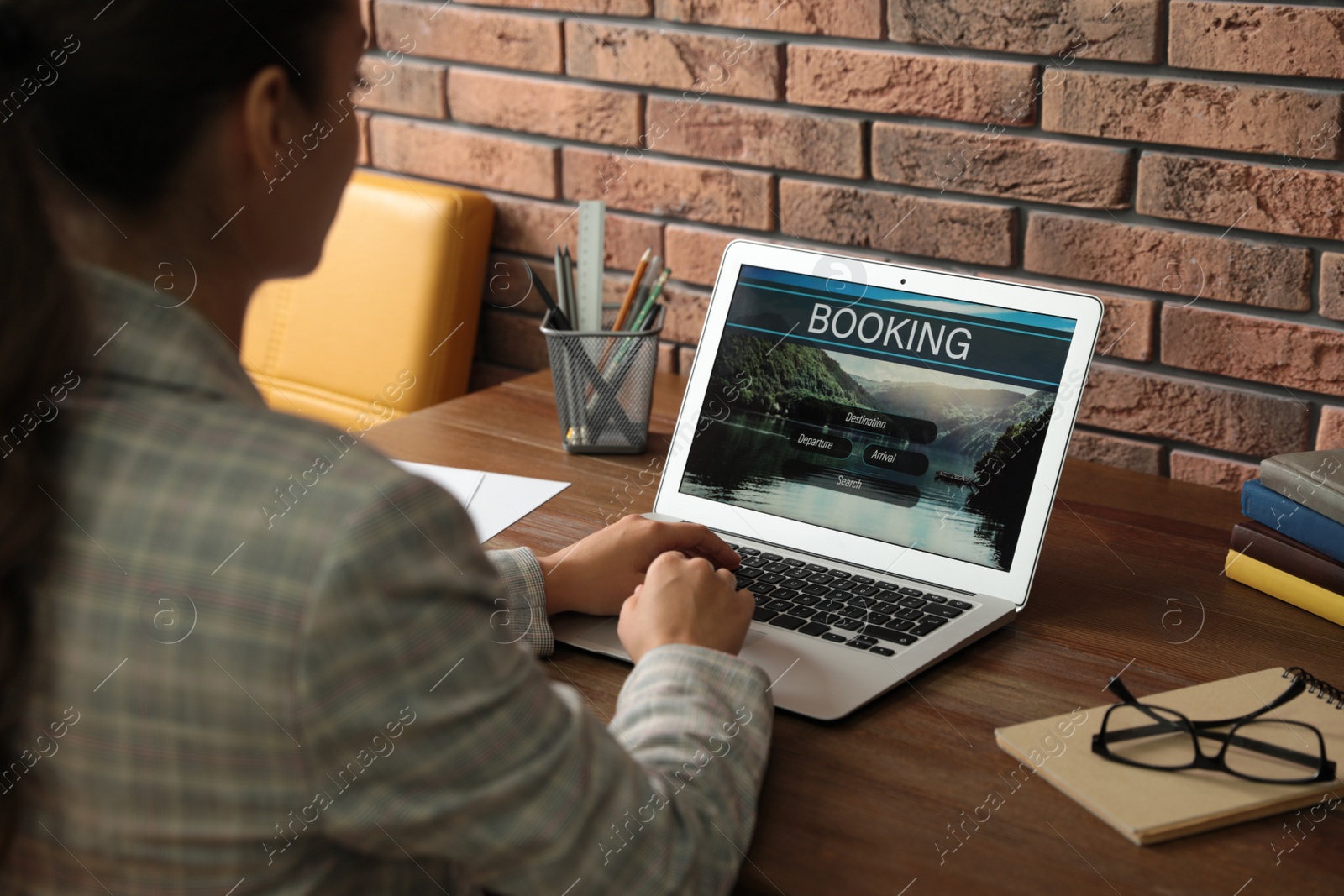 Photo of Young woman using laptop to plan trip, closeup. Travel agency website