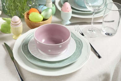 Photo of Easter celebration. Festive table setting with painted eggs.