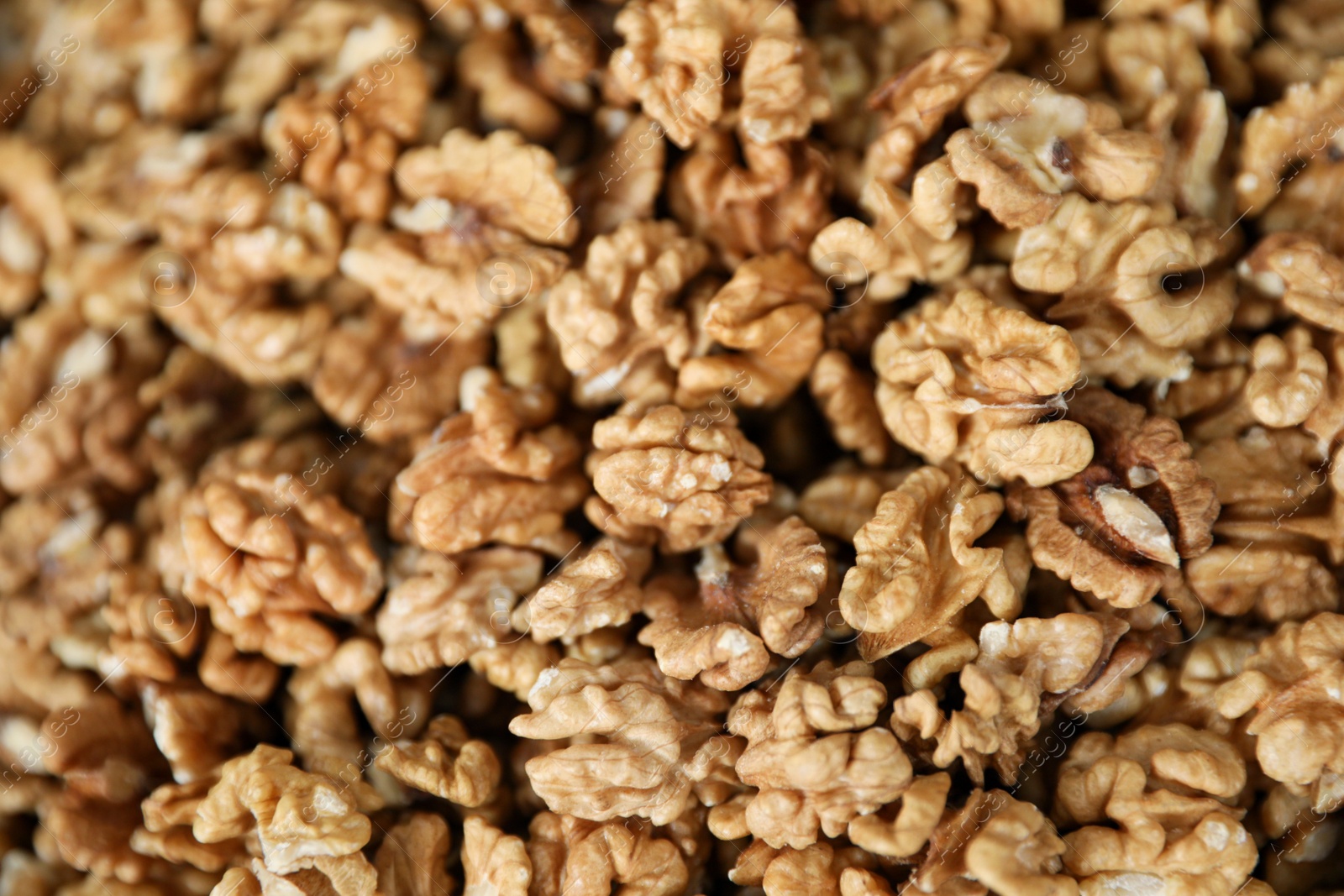 Photo of Heap of delicious walnuts as background, closeup view