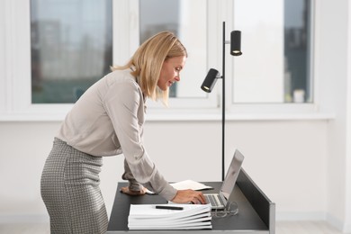 Photo of Businesswoman working with documents in modern office. Space for text