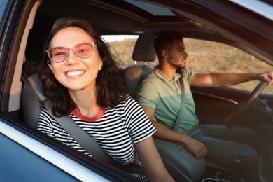 Photo of Happy young couple traveling by family car on summer day