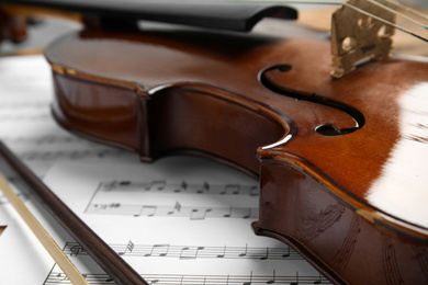 Beautiful violin, bow and note sheets, closeup