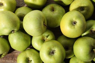 Photo of Many fresh apples on wooden table, top view