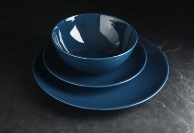 Empty clean ceramic dishware on grey table, closeup