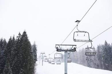 Ski lift at snowy mountain resort. Winter vacation