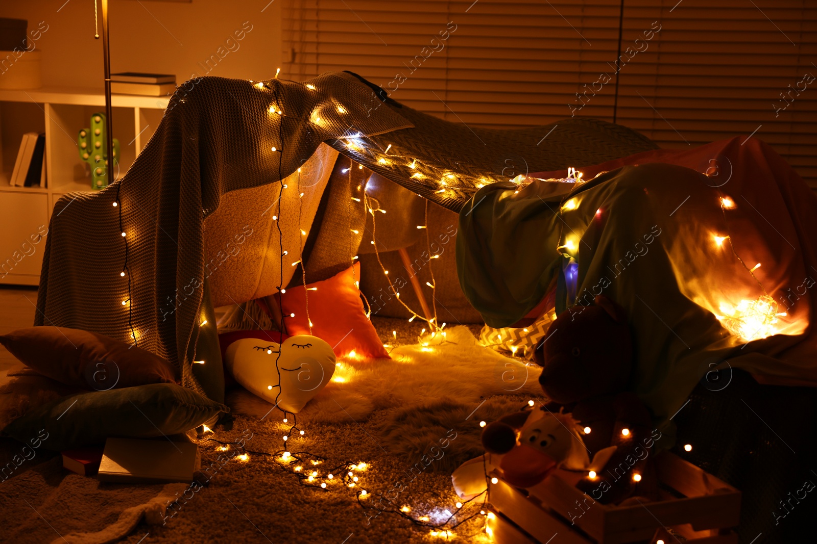 Photo of Beautiful play tent decorated with festive lights at home