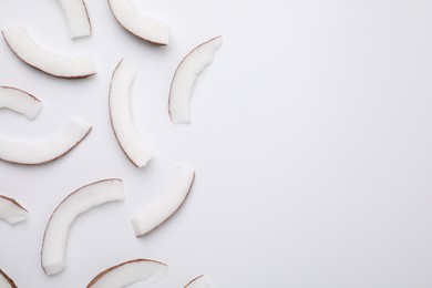 Pieces of fresh coconut on white background, top view