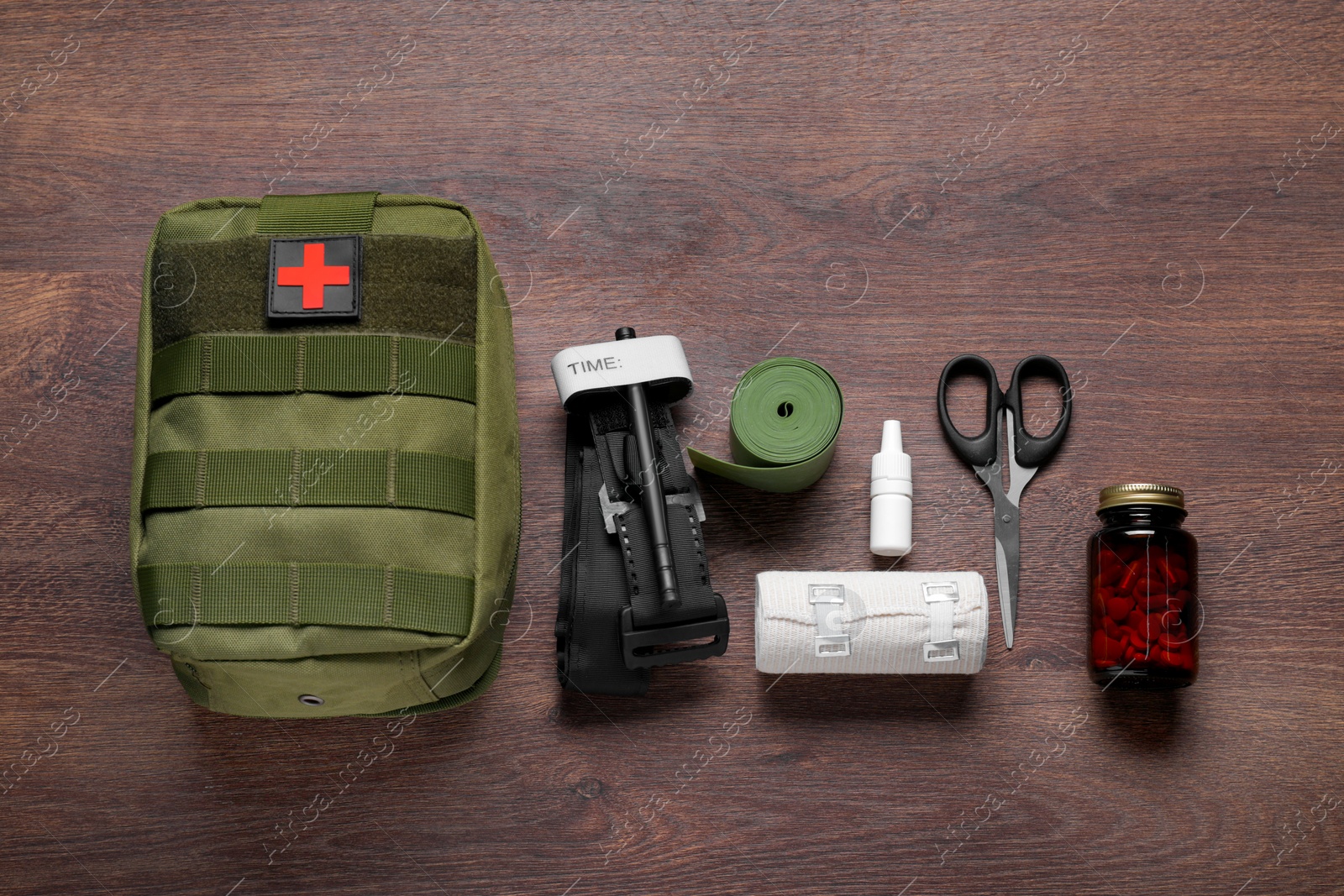 Photo of Flat lay composition with military first aid kit and tourniquet on wooden table