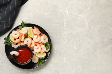 Photo of Tasty boiled shrimps with cocktail sauce, parsley and lime on light grey table, top view. Space for text