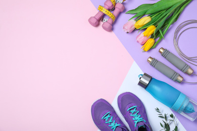 Photo of Flat lay composition with spring flowers and sports items on color background. Space for text