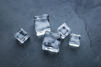 Photo of Crystal clear ice cubes on black table, above view