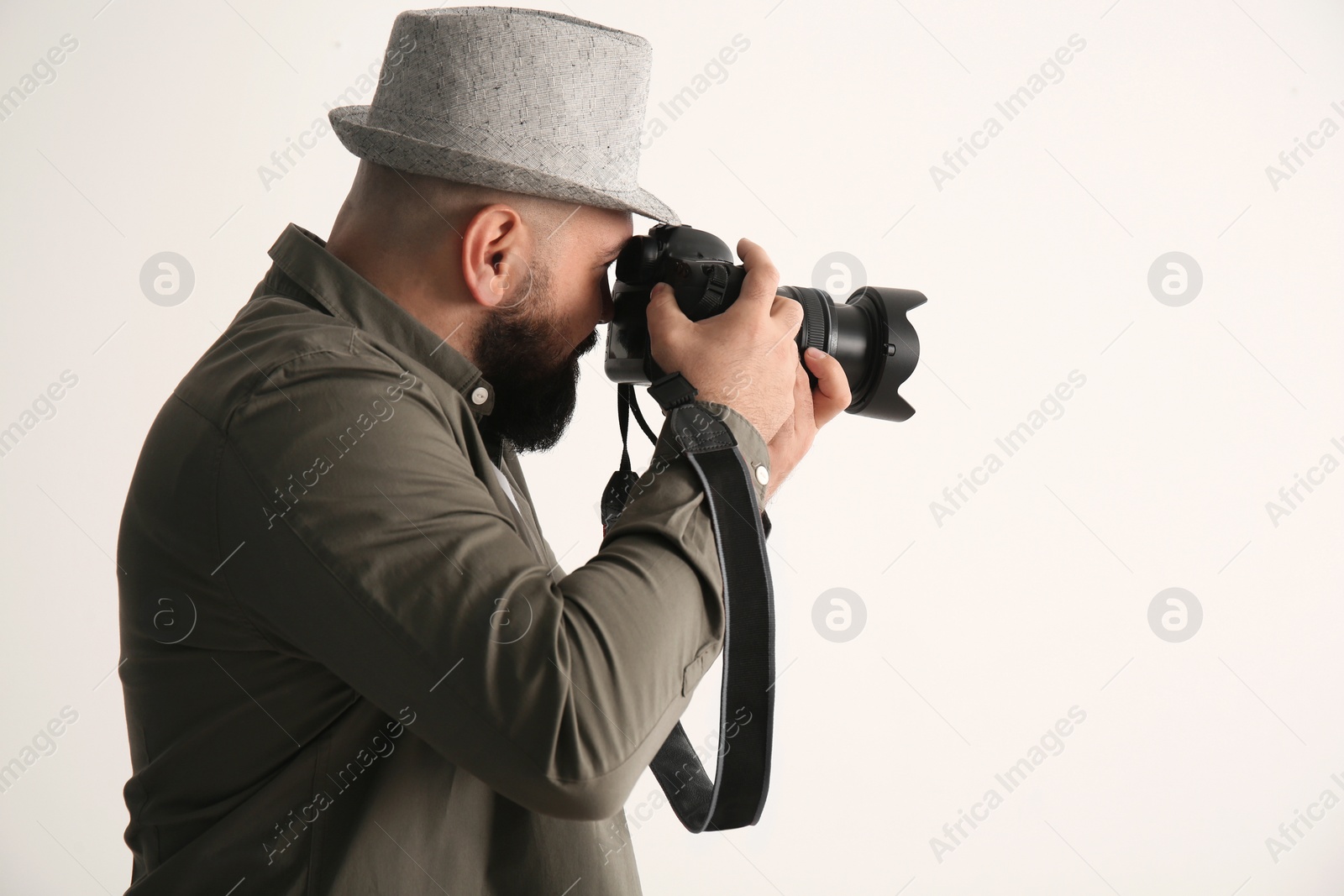 Photo of Male photographer with camera on white background
