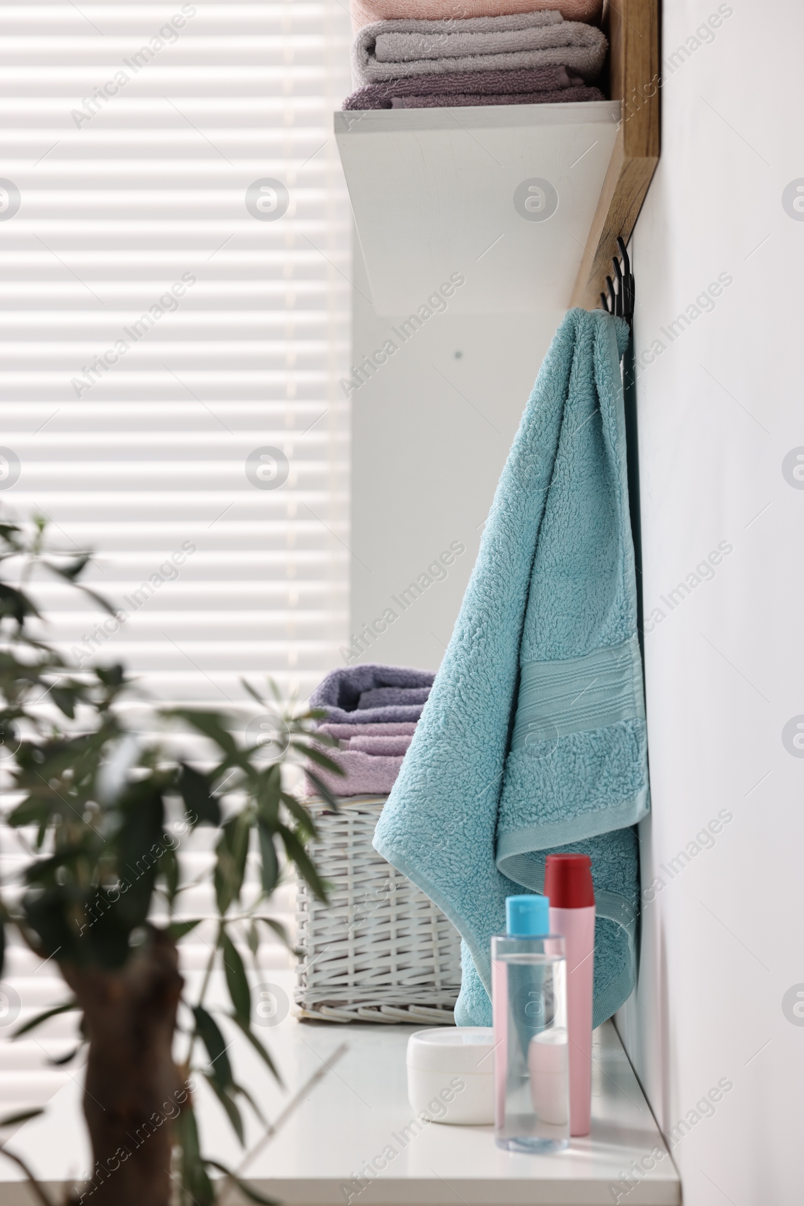 Photo of Fresh towels and toiletries on table indoors