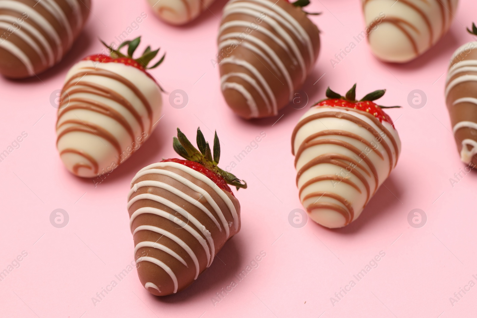 Photo of Delicious chocolate covered strawberries on pink background, closeup