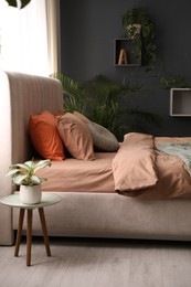 Photo of Bed with stylish cotton linens in room