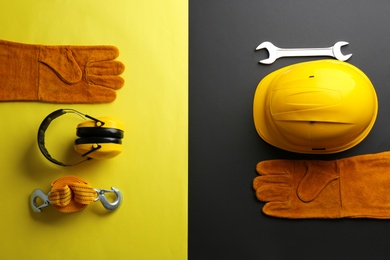 Photo of Flat lay composition with safety equipment and space for text on color background