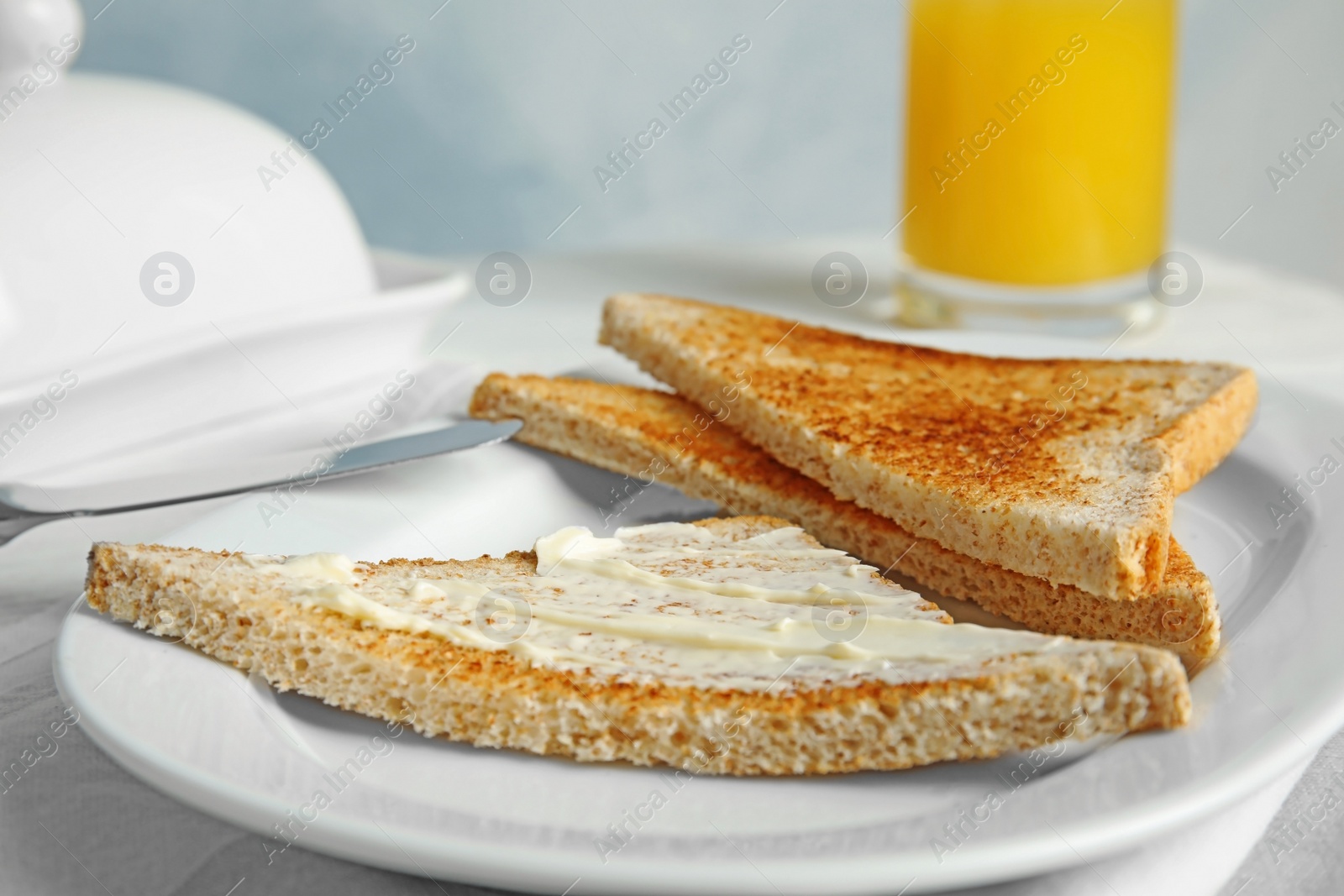 Photo of Plate with tasty bread for breakfast on table, closeup