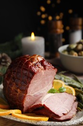 Delicious ham served with green beans and orange on plate, closeup. Christmas dinner