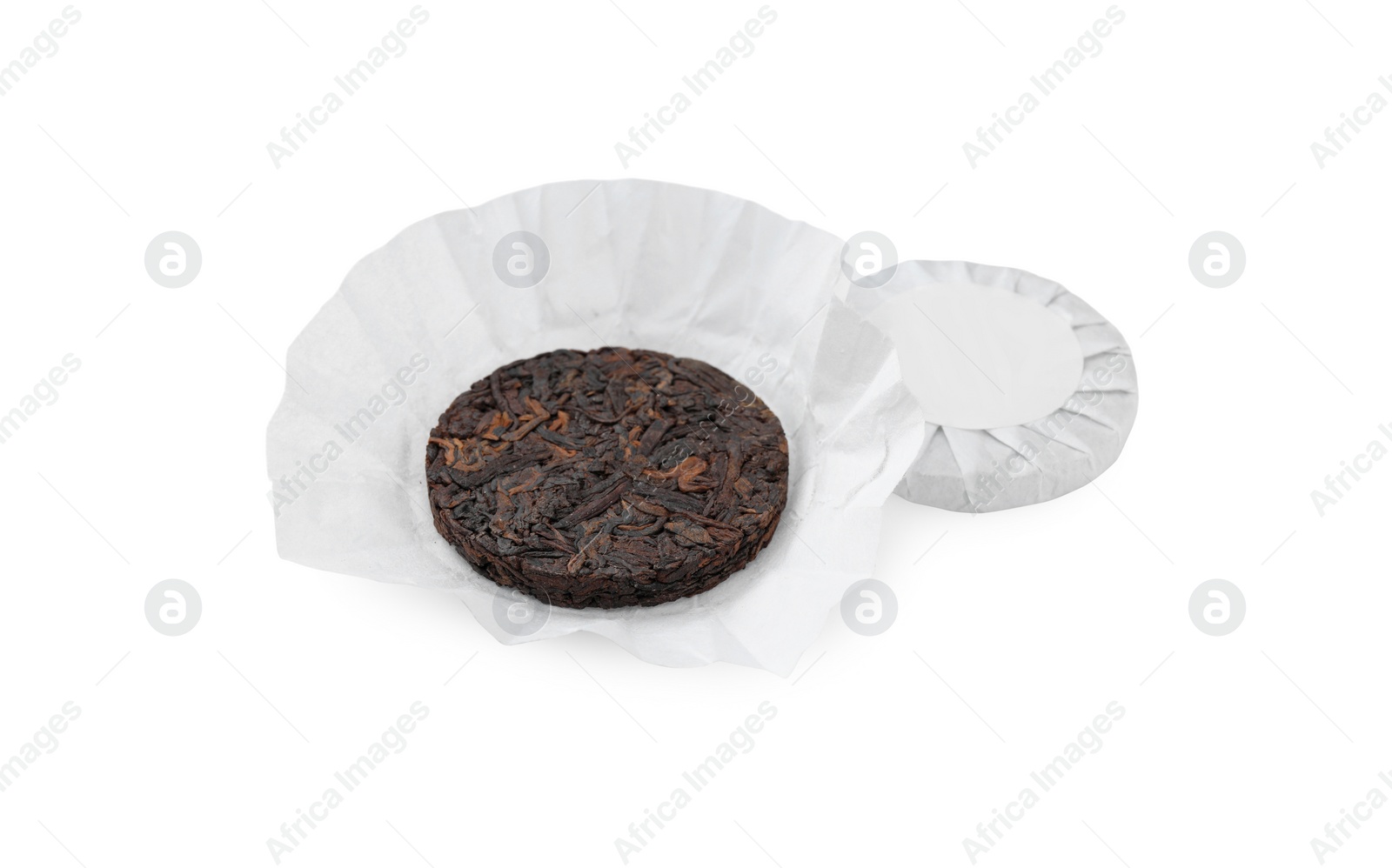 Photo of Disc shaped traditional Chinese pu-erh tea in paper wrap isolated on white