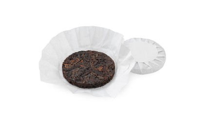 Photo of Disc shaped traditional Chinese pu-erh tea in paper wrap isolated on white