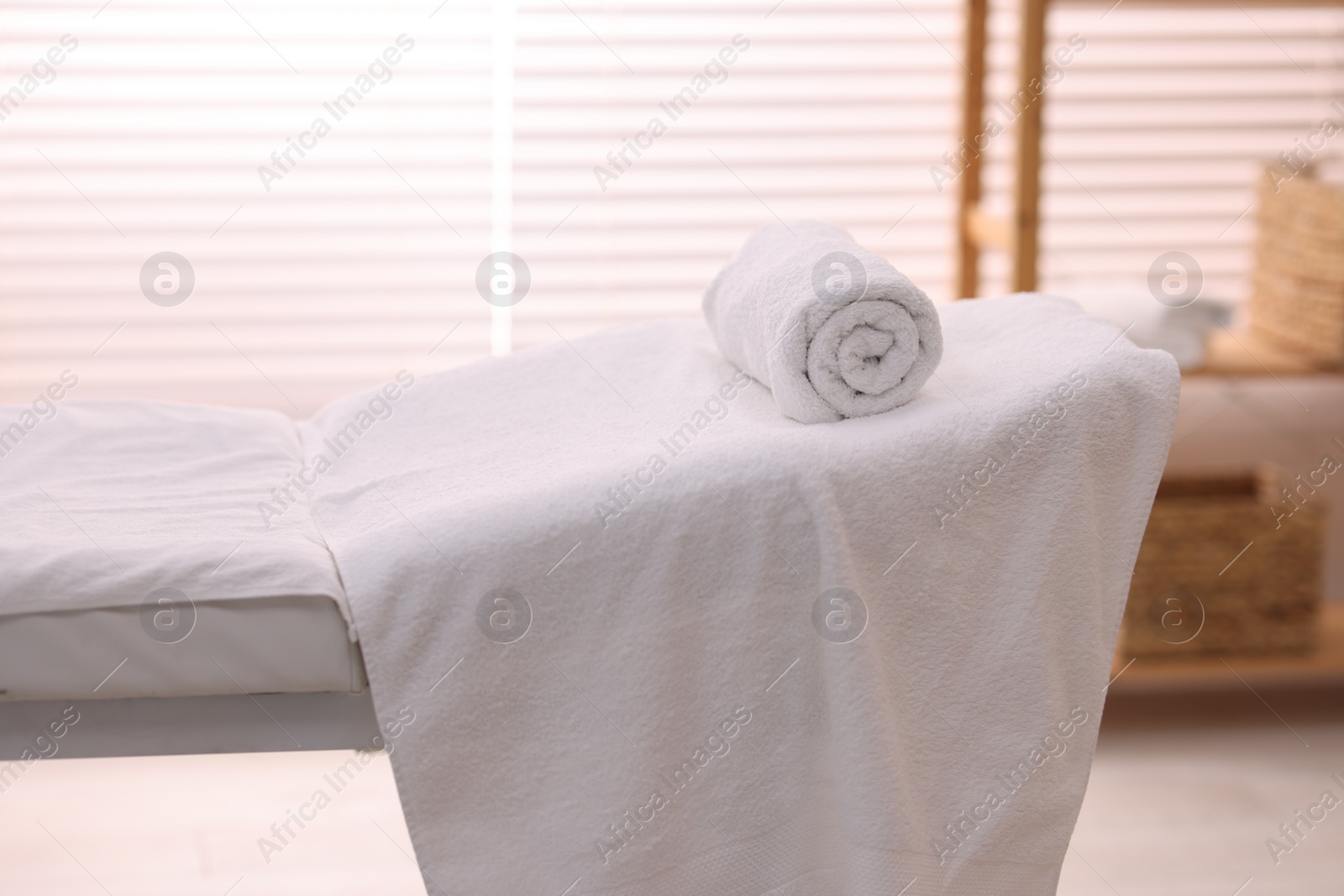 Photo of Rolled towel on massage table in spa center