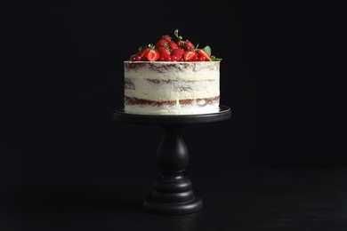 Delicious homemade cake with fresh berries on black background