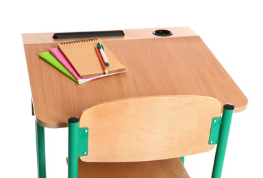 Wooden school desk with stationery on white background