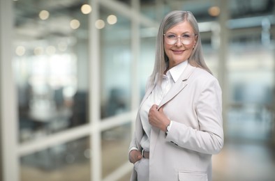 Image of Portrait of confident woman on blurred background, space for text