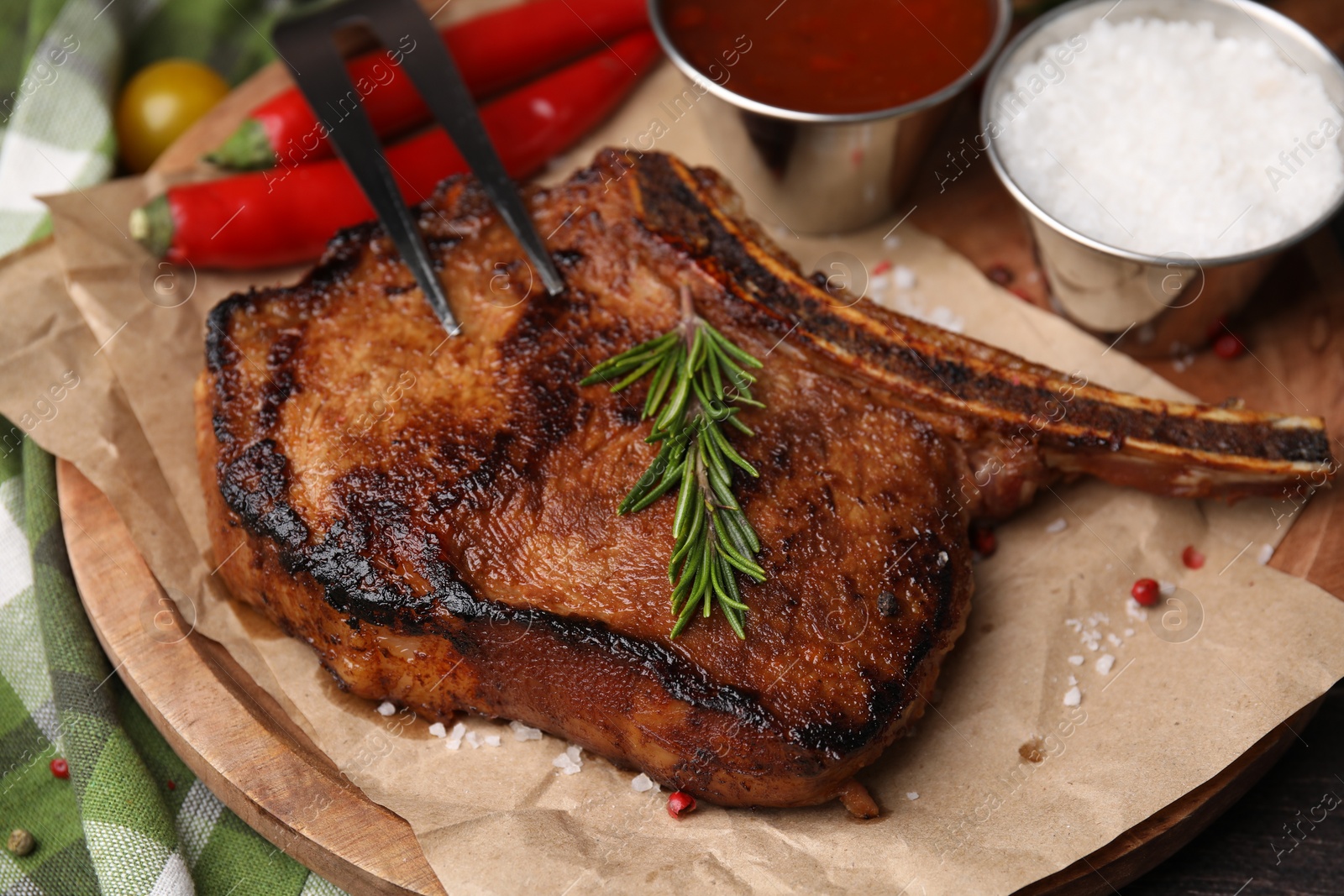 Photo of Tasty marinated meat, rosemary and spices on table, closeup