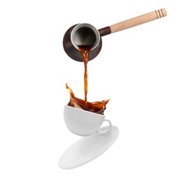 Pouring freshly brewed aromatic coffee from turkish pot into cup. Objects in air on white background