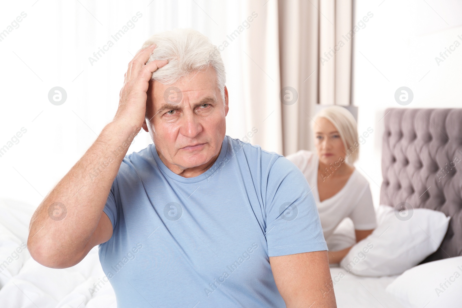 Photo of Mature couple with relationship problems ignoring each other in bedroom