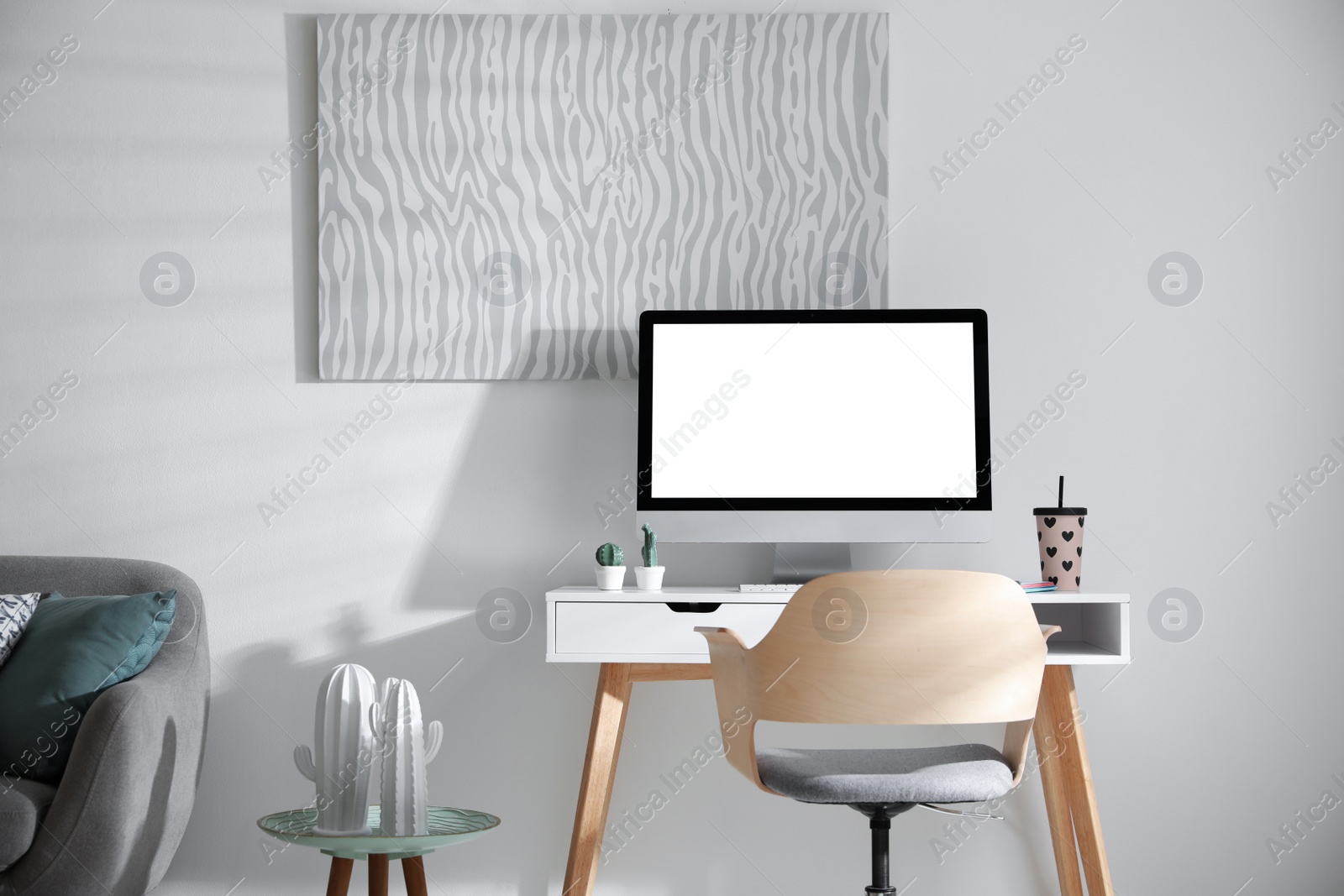 Photo of Comfortable office chair near desk with modern computer indoors