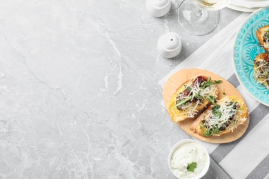 Delicious bruschettas with beef and cheese on marble table, flat lay. Space for text