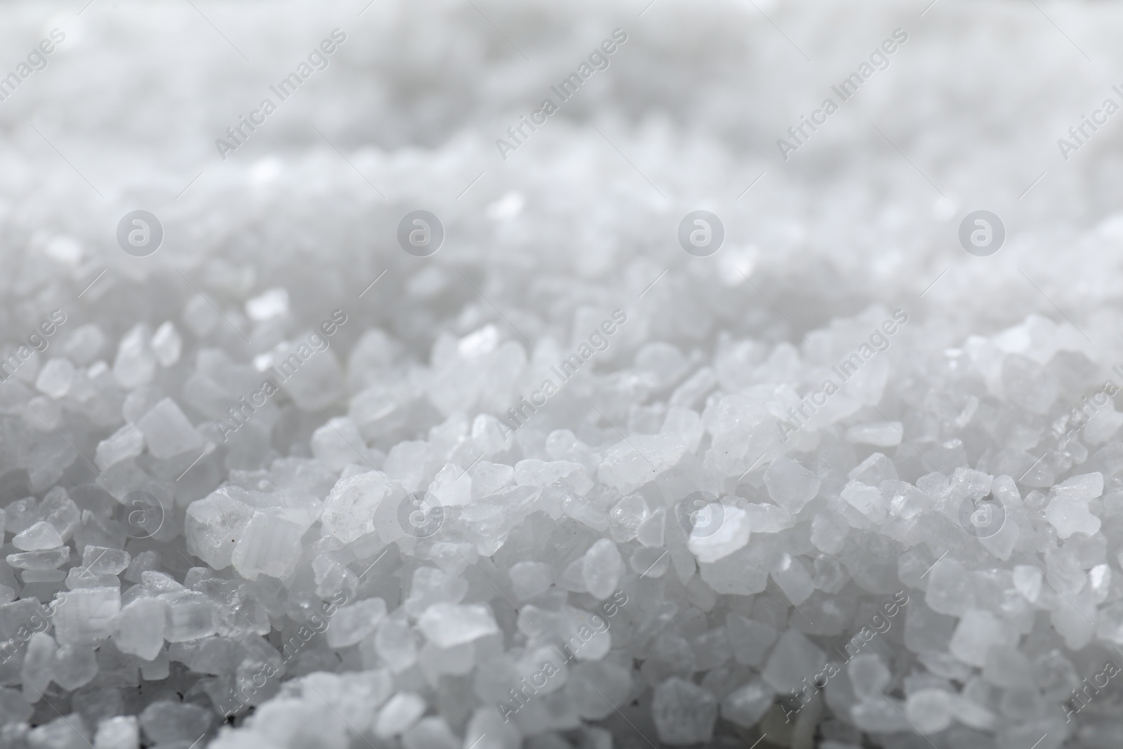 Photo of White natural salt as background, closeup view