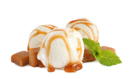 Photo of Delicious ice cream with caramel sauce, candies and mint on white background