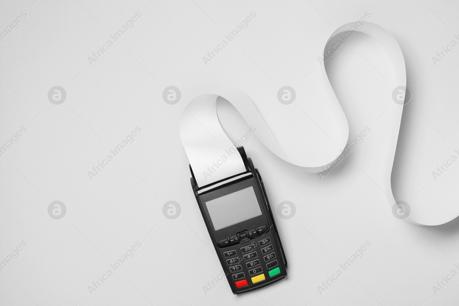 Photo of Payment terminal with thermal paper for receipt on light grey background, top view. Space for text