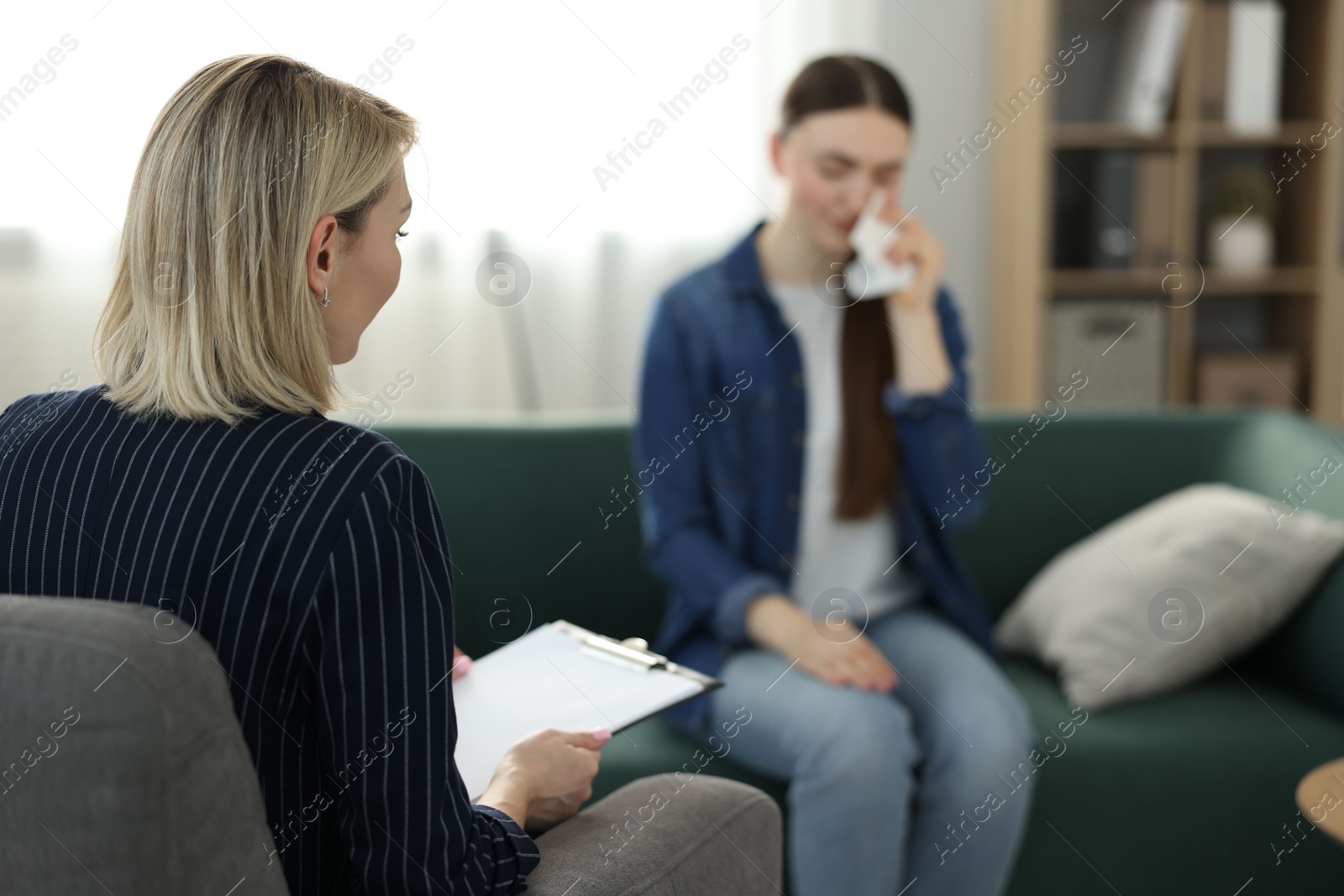 Photo of Professional psychotherapist working with patient in office