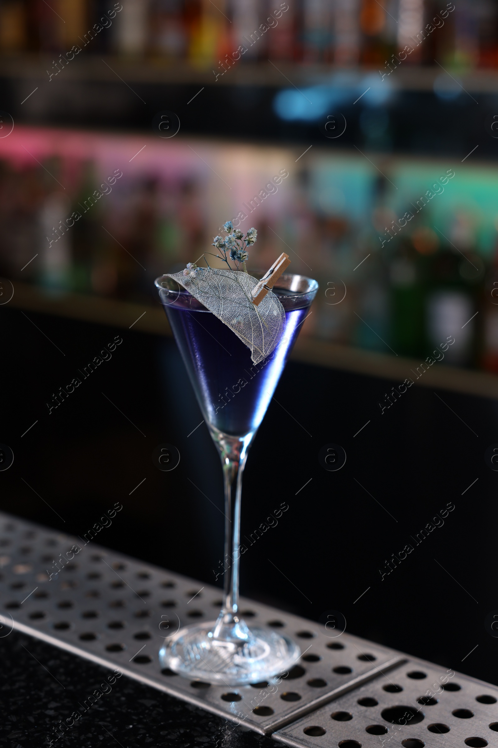 Photo of Fresh alcoholic cocktail in glass on bar counter