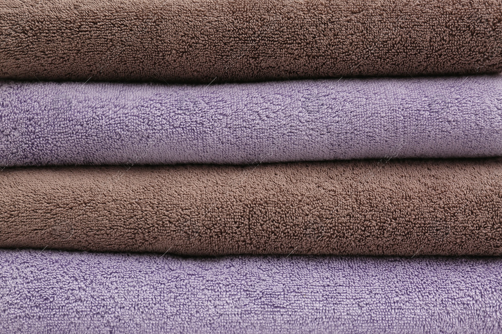 Photo of Stack of folded soft colorful towels as background
