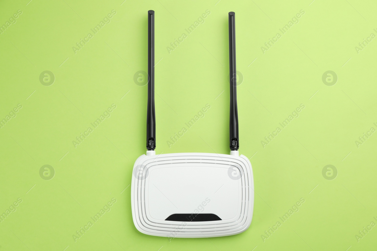 Photo of Modern Wi-Fi router on green background, top view