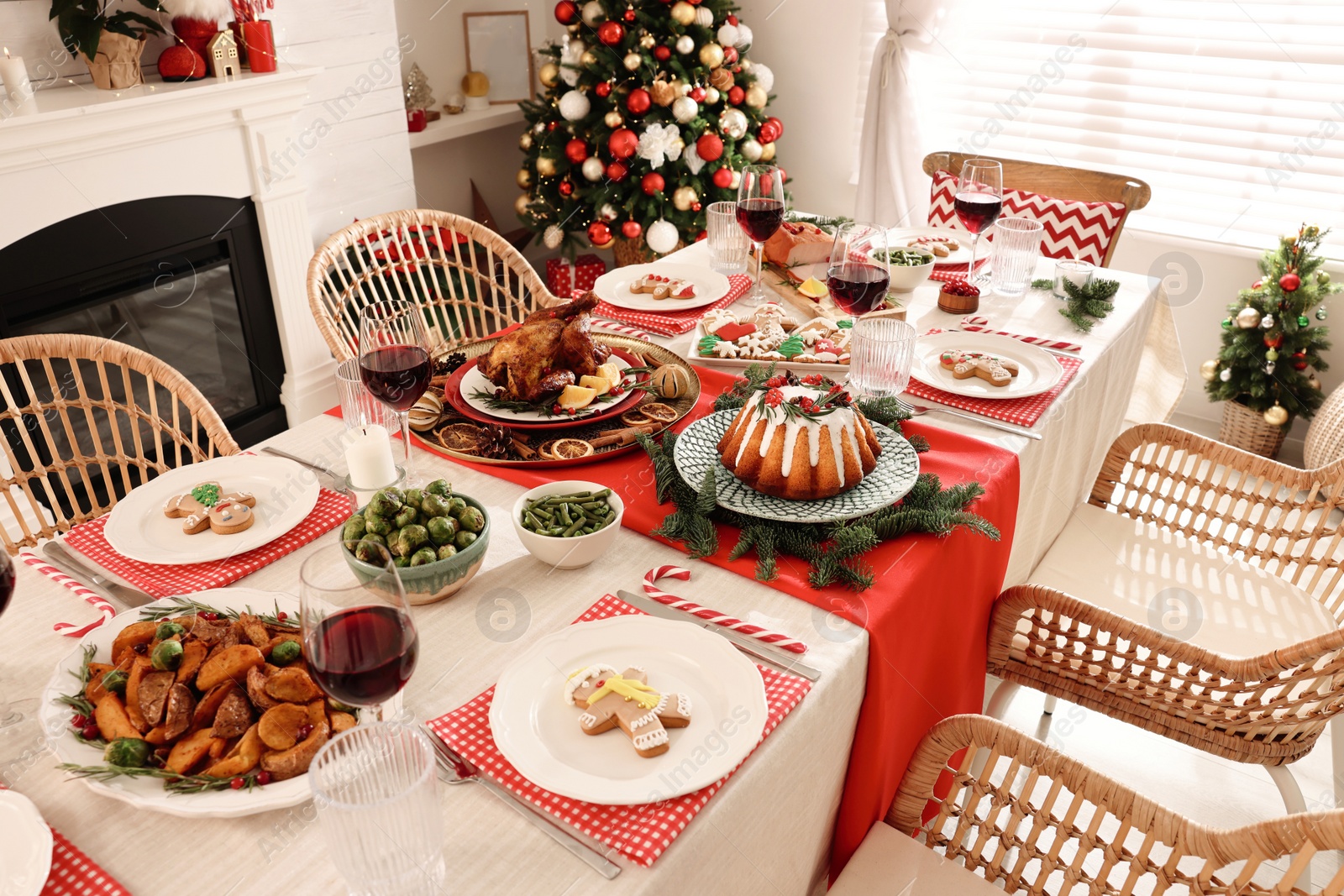 Photo of Festive dinner with delicious food and wine on table indoors. Christmas Eve celebration