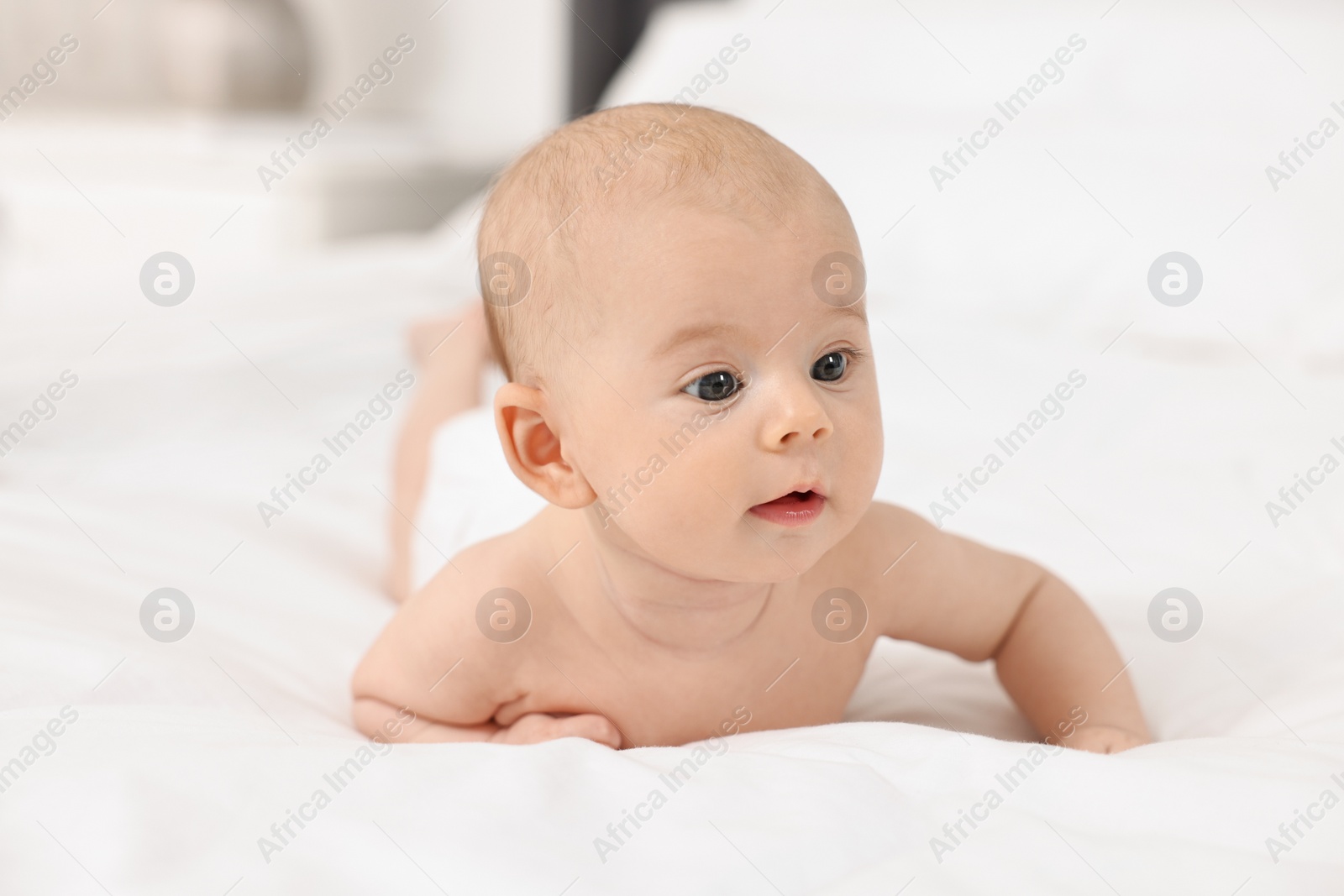 Photo of Cute little baby on bed at home