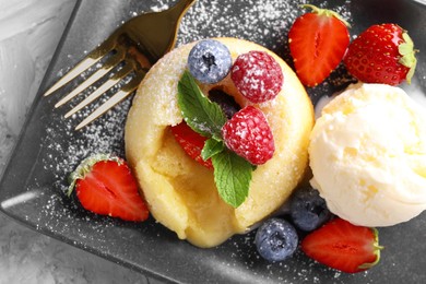 Tasty vanilla fondant with white chocolate, berries and ice cream on light grey table, top view