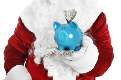 Photo of Santa Claus holding piggy bank with dollar banknotes on white background, closeup