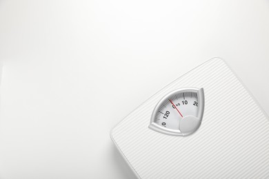 Photo of Scales on white background, top view. Space for text